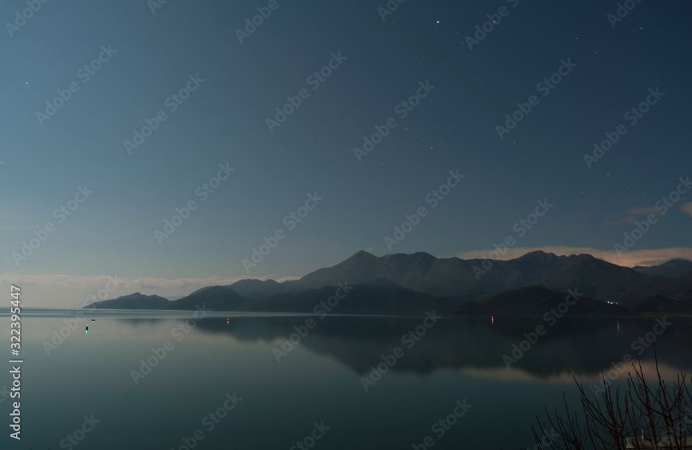 Skadar lake with mountain range at night long exposure