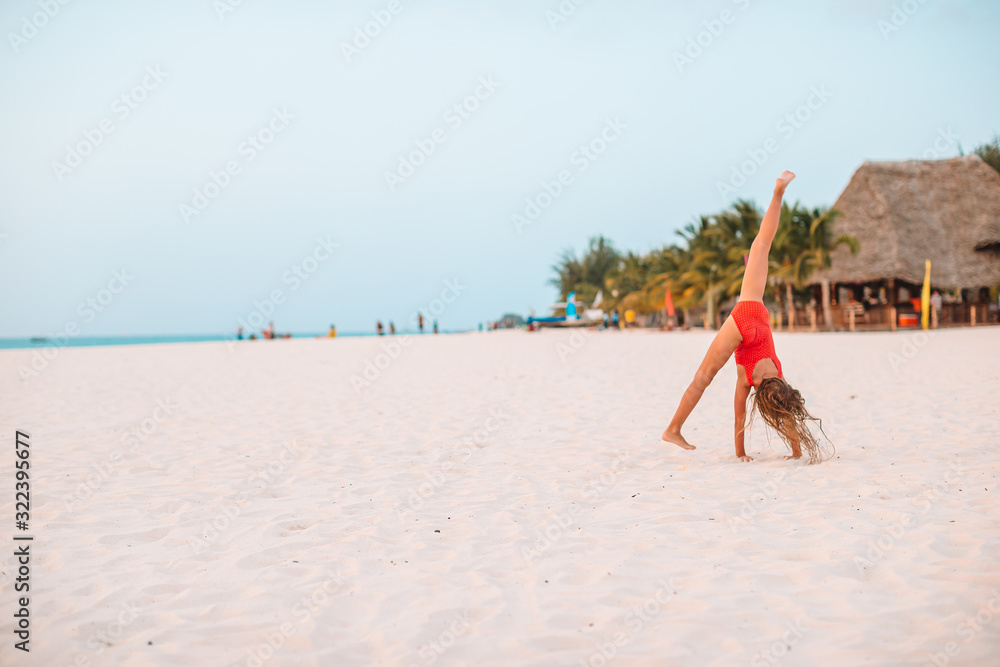 Adorable little girl at beach on her summer vacation Adorable little girl at beach on her summer vacation
