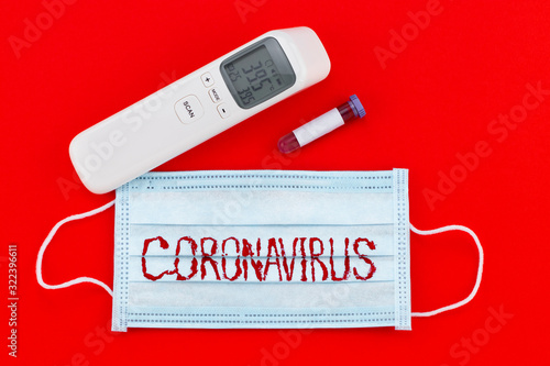 protective mask with CORONAVIRUS and test tube with blood. WUHAN virus concept