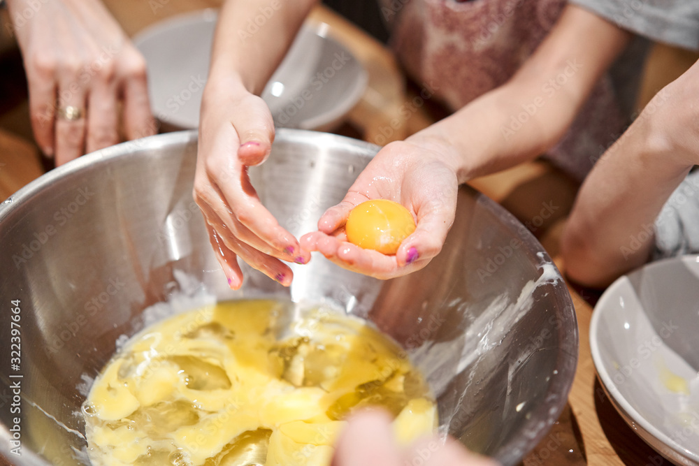 Separate the egg into protein and yolk. Funny master class for children on baking pizza and italian ice cream. Young children learn to cook. Kids preparing homemade pizza. Little cook. Separate the egg into protein and yolk. Funny master class for children on baking pizza and italian ice cream. Young children learn to cook. Kids preparing homemade pizza. Little cook.