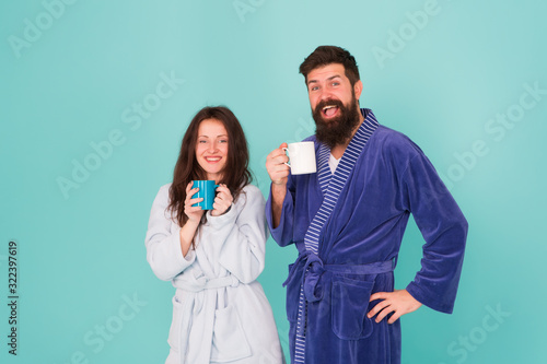 Vacation starting here. Hotel breakfast service. Coffee is our tradition. Man and woman happy together. Family traditions. Couple in cozy bathrobes enjoy lazy weekend. Drinking coffee. Spa and relax