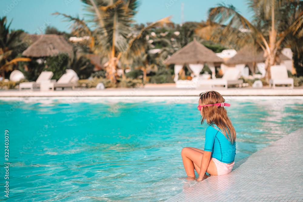 Fototapeta premium Adorable little girl swimming at outdoor swimming pool