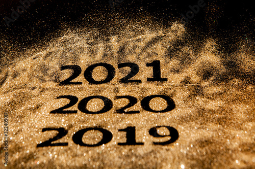 Beautiful sparkling Golden Numbers of 2019 to 2020 on black background for design, happy new year concept