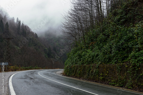 Bending wet road among the hills.