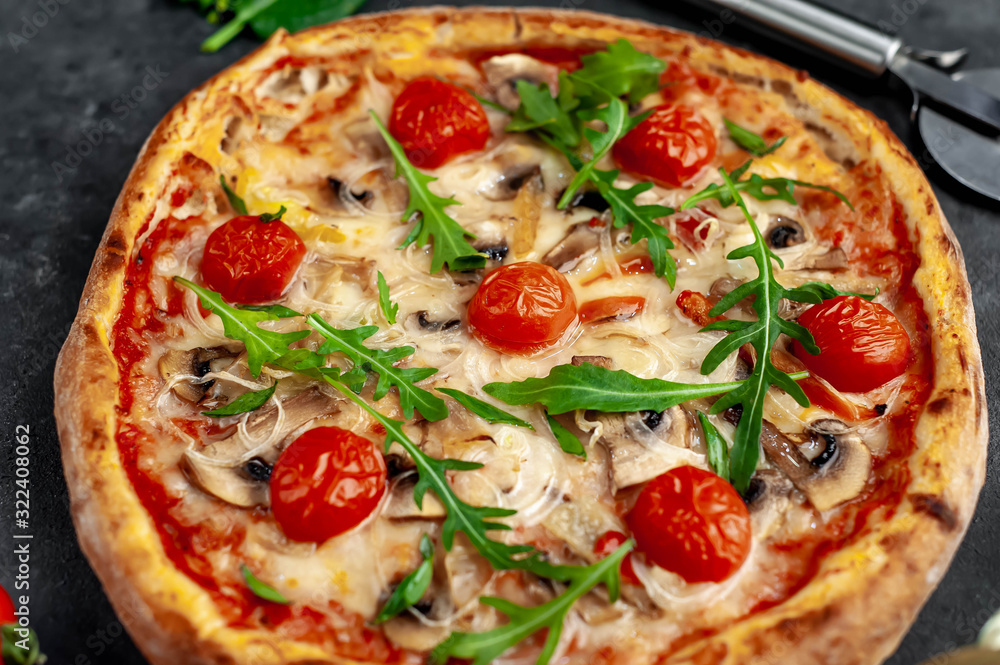 tasty italian pizza with mozzarella cheese, mushrooms, tomato, bell pepper, onion on a stone background