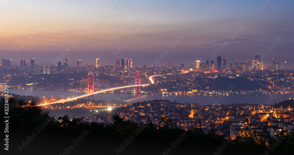 Panoramic view from Camlica hill to 15 July Martyrs bridge with scyscrapers in the background.The blue hour image.Romantic  Istanbul conception.Turkey.
