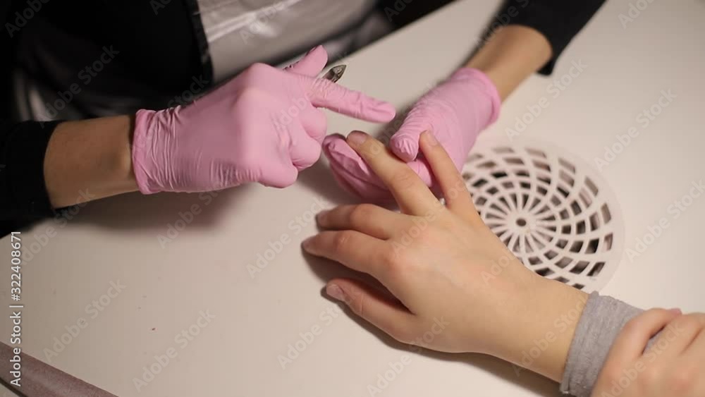 Professional manicurist removes dry cuticle skin near nails cutting it with scissors. Closeup video of professional manicure at beauty salon Professional manicurist removes dry cuticle skin near nails cutting it with scissors. Closeup video of professional manicure at beauty salon
