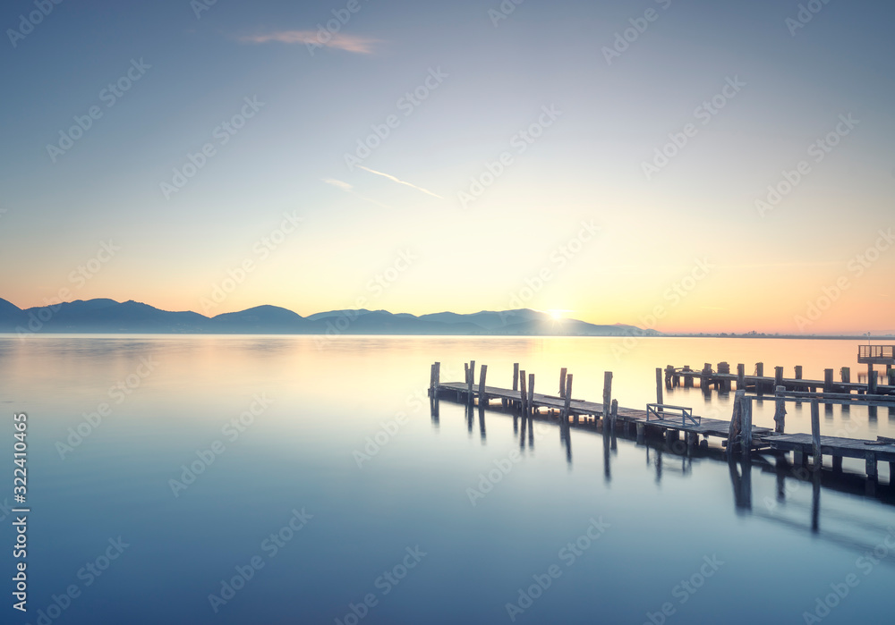Three Wooden piers or jetties at sunrise. Torre del Lago Puccini, Versilia Tuscany, Italy