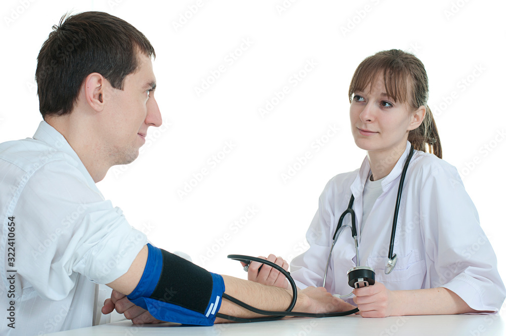 a female doctor measures her patient's blood pressure with tonometers