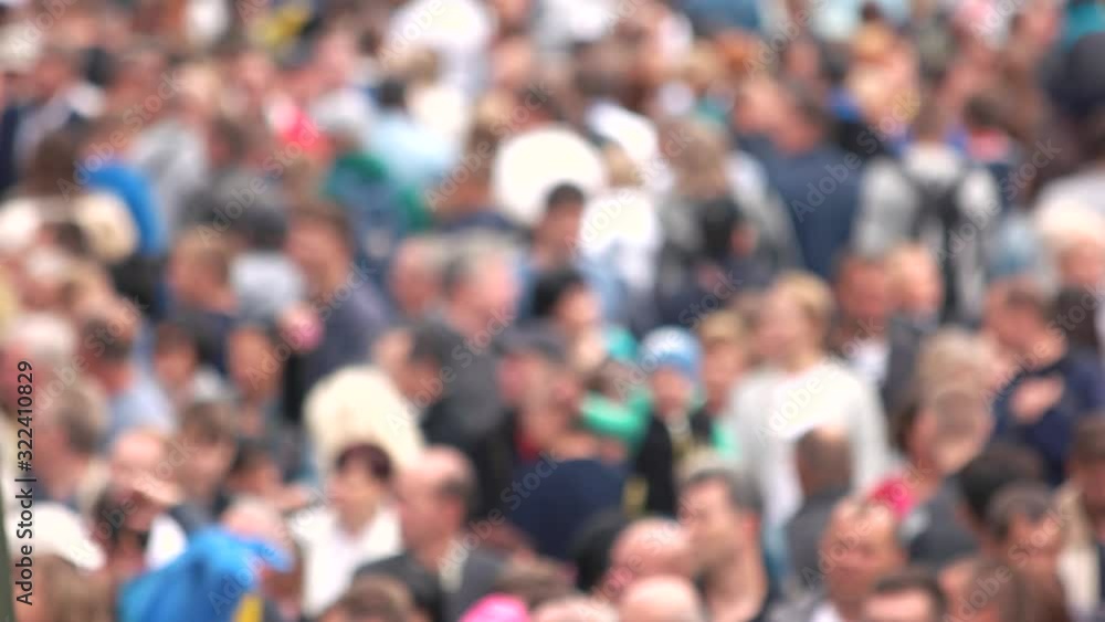 Blurred crowd of people at the stadium. Background of defocused and blurred crowd of people walking on busy street. Blurred crowd of people at the stadium. Background of defocused and blurred crowd of people walking on busy street.