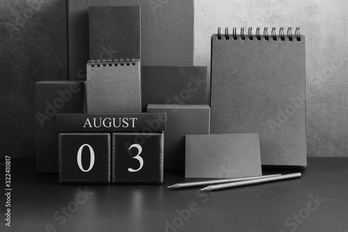 August 3th. Day 3 of month. Wood cube calendar with date month and day. Trendy classic black color. Lot of empty pages template for daily notes.