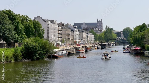 Nantes is the capital of the Pays de la Loire Région in northwestern France, on the Loire River. View of the erdre river in Nantes, in the west of France. Boats on the water, filmed in summer. photo