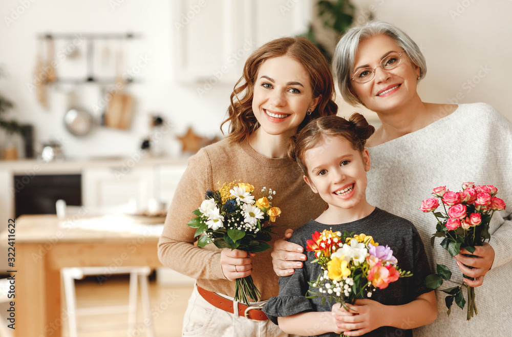 mother's day! three generations of family mother, grandmother and daughter congratulate on the holiday, give flowers mother's day! three generations of family mother, grandmother and daughter congratulate on the holiday, give flowers