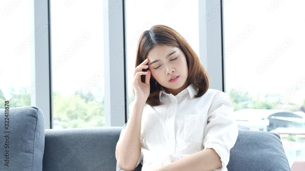 Tension stress asian women have a migraine headache touching her temples feeling stress upset depressed. Strong headache migraine exhausted girl can't sleep. Office syndrome unhealthy person. Tension stress asian women have a migraine headache touching her temples feeling stress upset depressed. Strong headache migraine exhausted girl can't sleep. Office syndrome unhealthy person.