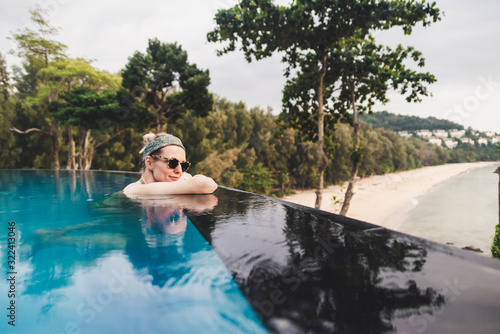 Woman relaxing in infinity pool, Nai Thon Beach, Phuket, Thailand photo