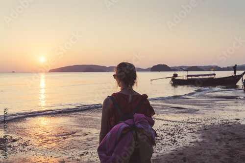 Rear view of woman on the beach at sunset, Noppharat Thara Beach, Ao Nang, Krabi, Thailand photo