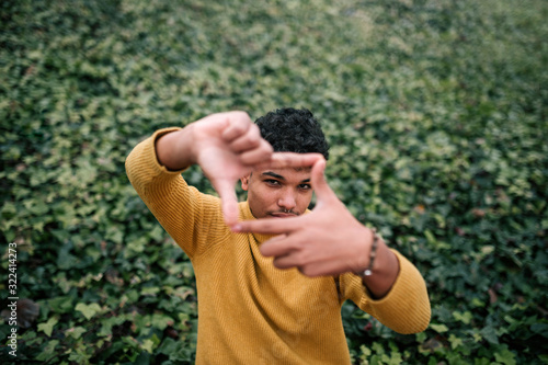 Young man making a finger frame with his hands photo