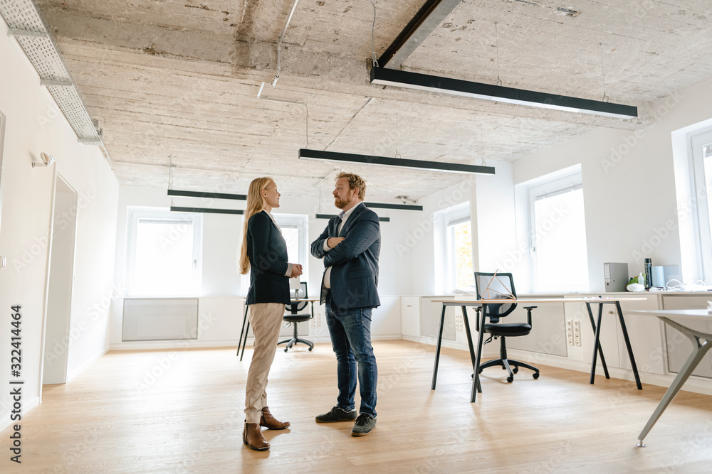 Businessman and businesswoman talking in office Businessman and businesswoman talking in office