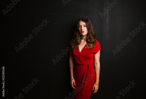 Portrait of young woman wearing red dress