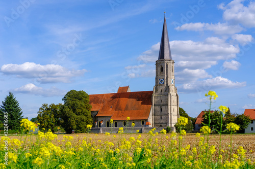 Germany, Bavaria, Aigen am Inn, Summer meadow in front of Maria Himmelfahrt zu St. Leonhard church photo