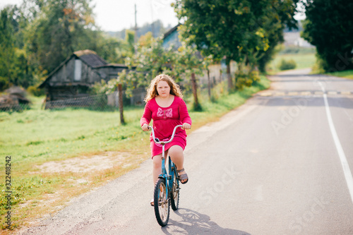 Handsome young caucasian girl rides a bike