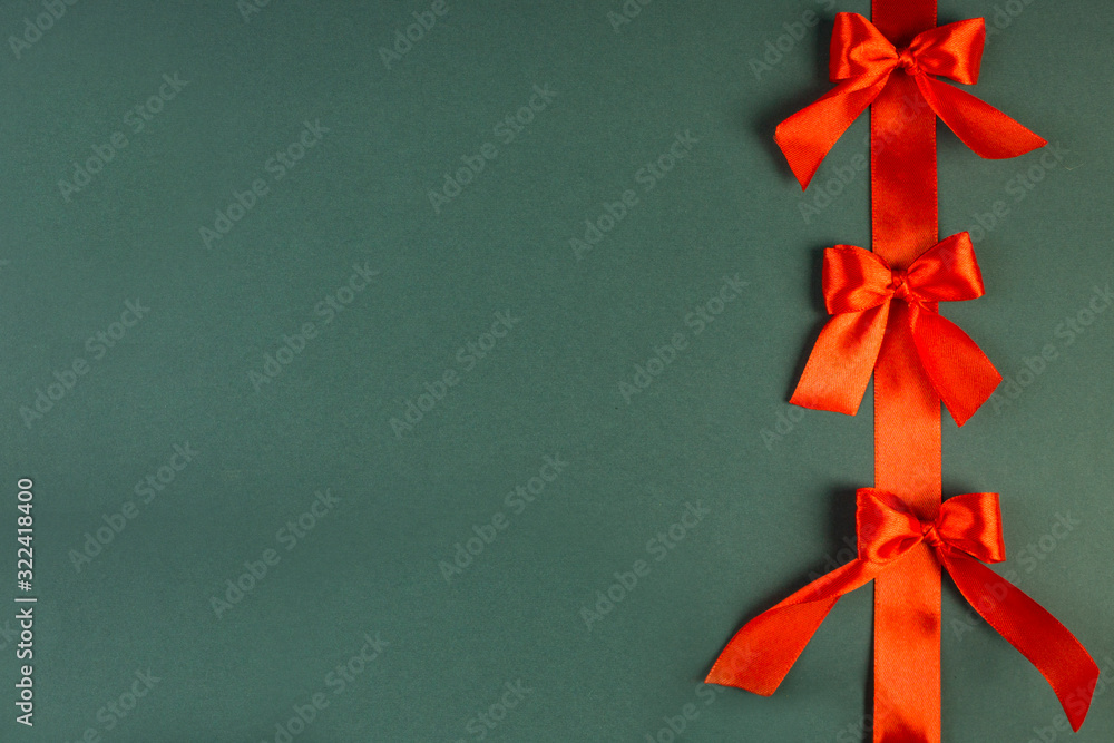 Shiny red satin ribbon on background, place for text, festive concept