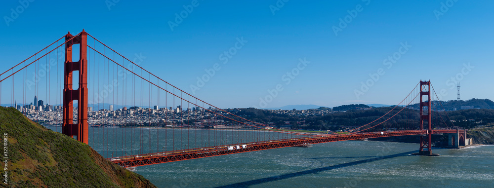 Obraz premium Full view of the Golden Gate Bridge on a clear day in the city by the bay ,skyline in background 