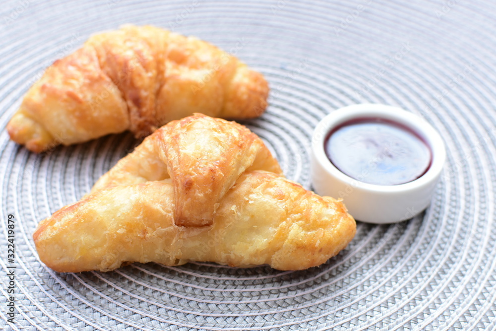Small butter croissant, accompanied by blackberry jam Small butter croissant, accompanied by blackberry jam