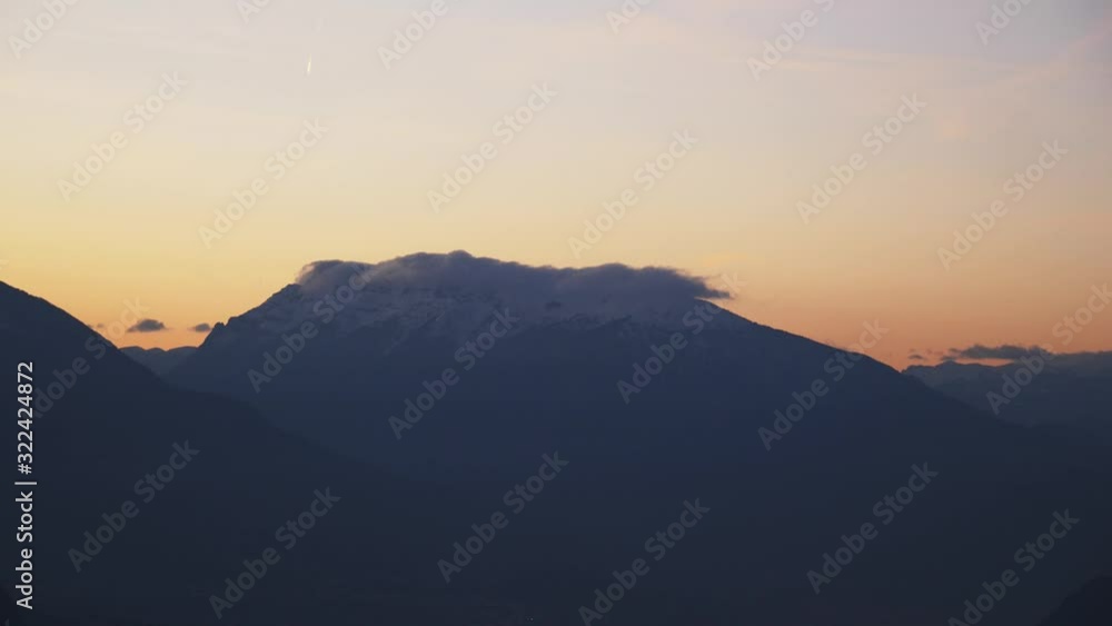 Amazing view, mountain peak surrounded with clouds during sunset, still shot in the Italian Dolomites. Amazing view, mountain peak surrounded with clouds during sunset, still shot in the Italian Dolomites.