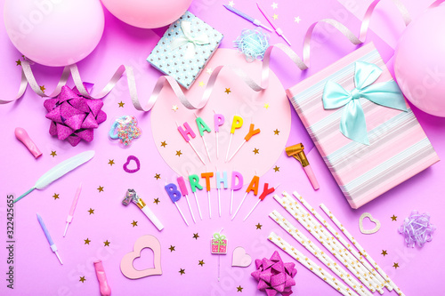 Colorful celebration background with various party confetti, balloons, gifts, and decoration on pink background. © Limages Studio