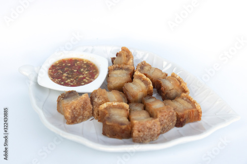Pork cutlets in a white tray on a white background