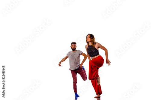 Pair of dancers isolated on the white wall © qunica.com