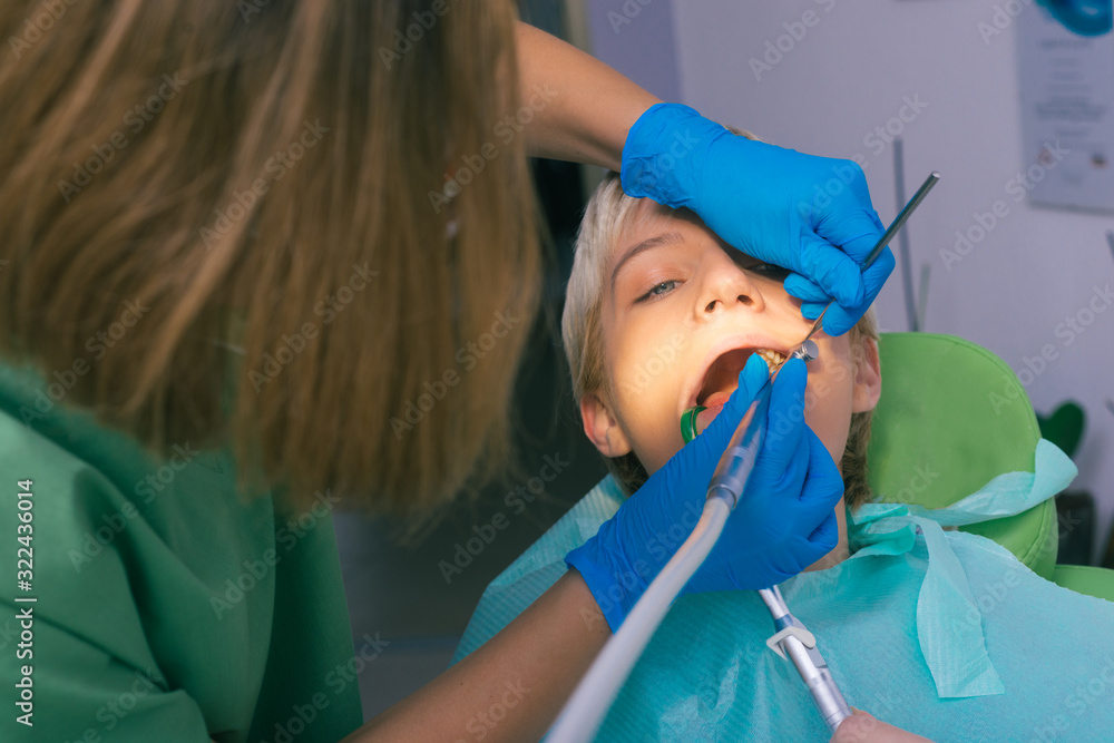 Detailed dental examination on a female patient in the dentist's office Detailed dental examination on a female patient in the dentist's office