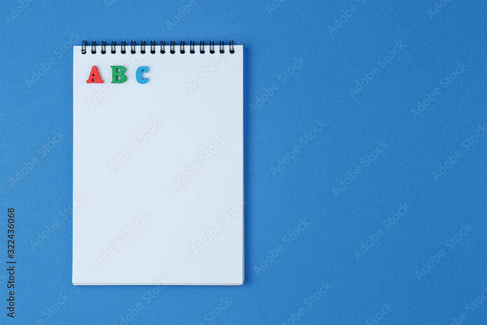 Notebook with ABC letters on blue background Notebook with ABC letters on blue background
