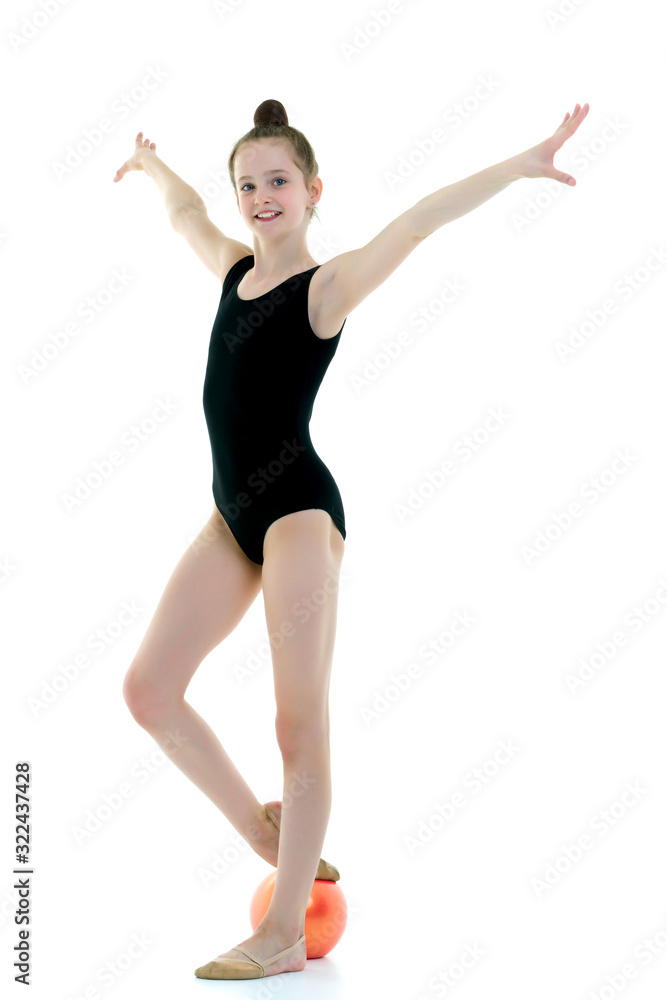 Obraz premium little girl is engaged in fitness with a ball.