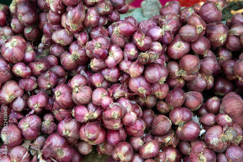 Background and texture of organic red onions with uneven shapes and rough red skins.. photo