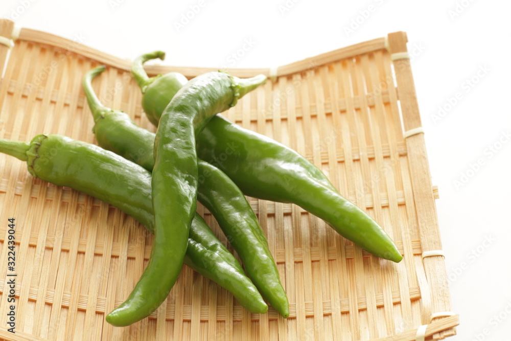 Japanese green pepper on bamboo basket for cooking image Japanese green pepper on bamboo basket for cooking image