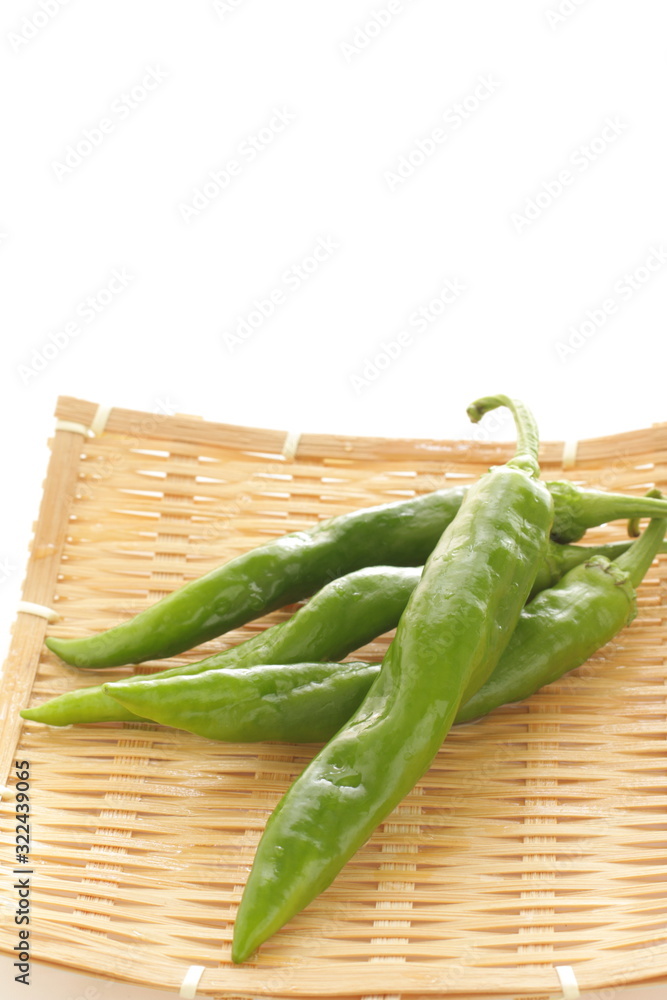 Japanese green pepper on bamboo basket for cooking image Japanese green pepper on bamboo basket for cooking image