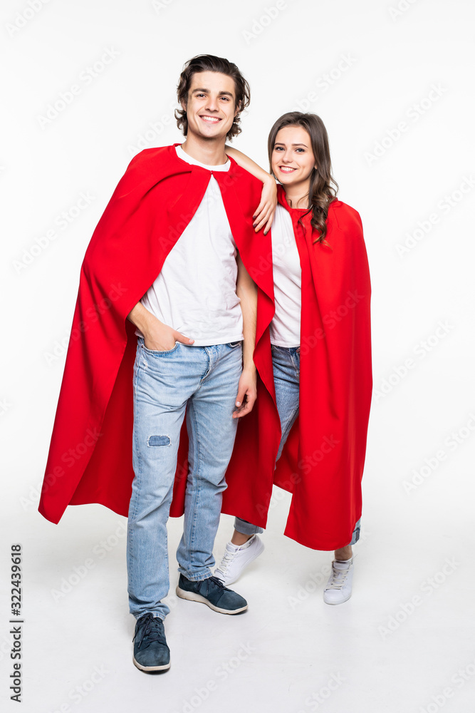 Young couple wearing red hero look demonstrating arm muscles isolated on white background Young couple wearing red hero look demonstrating arm muscles isolated on white background