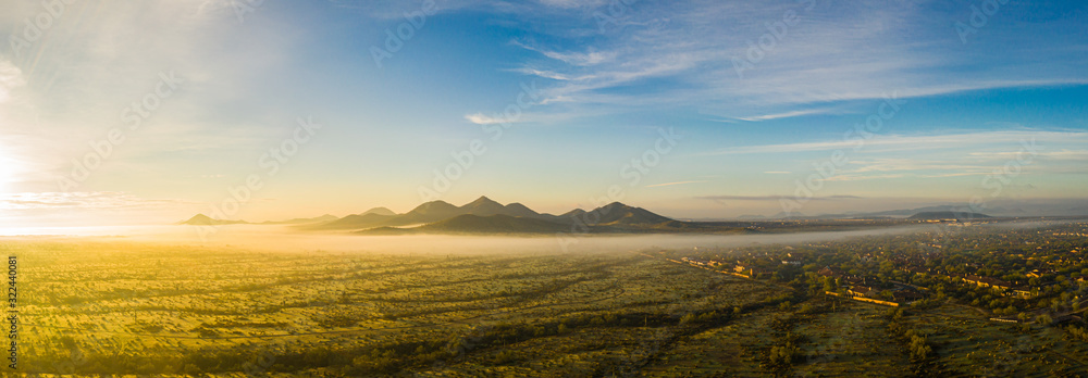 Panorama image from a drone of fog in the Sonoran Desert of Arizona during sunrise.