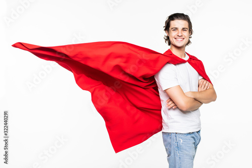 Fotografie Young happy man in red superhero cape over white background