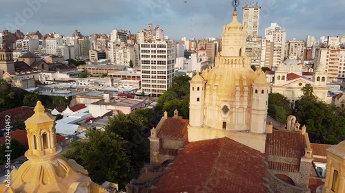 Drone fly over the Cathedral of Córdoba - oldest church in Argentina. Aerial view of catholic church and skyline cityscape view on sunrise in the morning. Cordoba, Argentina.