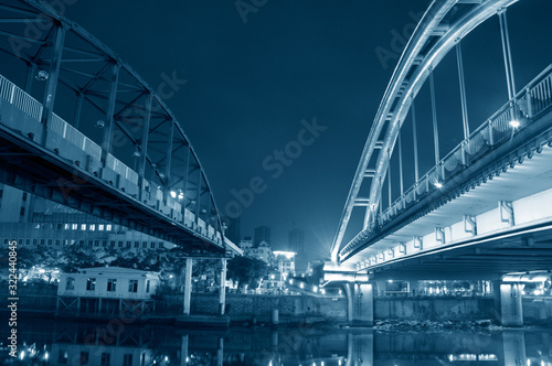 Jiangmen, Guangdong, China, the Jiangmen Iron bridge(Left) and Shenglli bridge(Right) at night in Pengjiang Distric of Jiangmen, Guangdong Province, China..