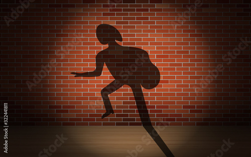 Shadow of a thief on a brick wall