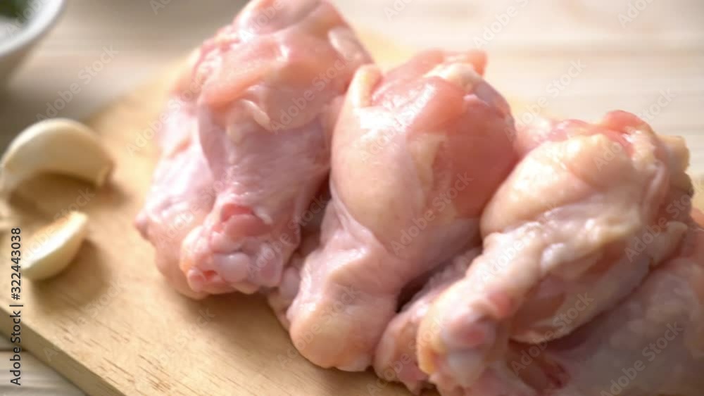 fresh raw chicken wings (drumette or drumstick) on wooden board with ingredients fresh raw chicken wings (drumette or drumstick) on wooden board with ingredients