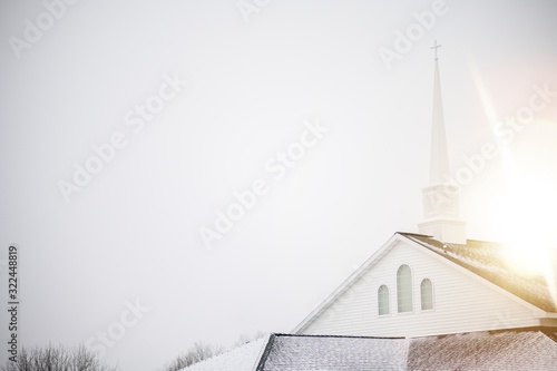 Obraz na plátne Low angle shot of a church with a staple under the bright sky