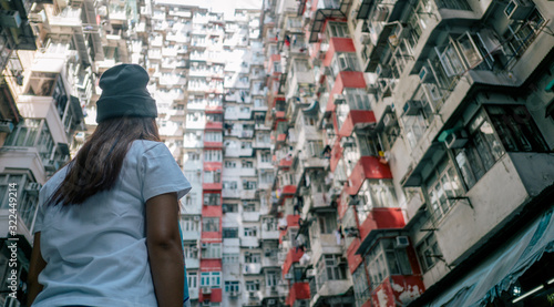 Beautiful woman looking to Old apartment in Hong Kong, vintage tone.,Travel concept