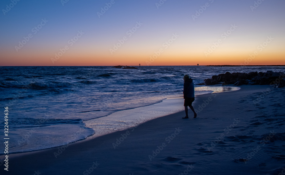 Man testing ocean waters sunrise sunset