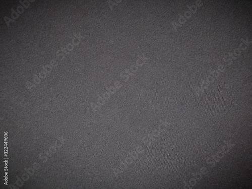Dark background. Abstract background made of dark fabric. Template for copying space. Background with vignette.