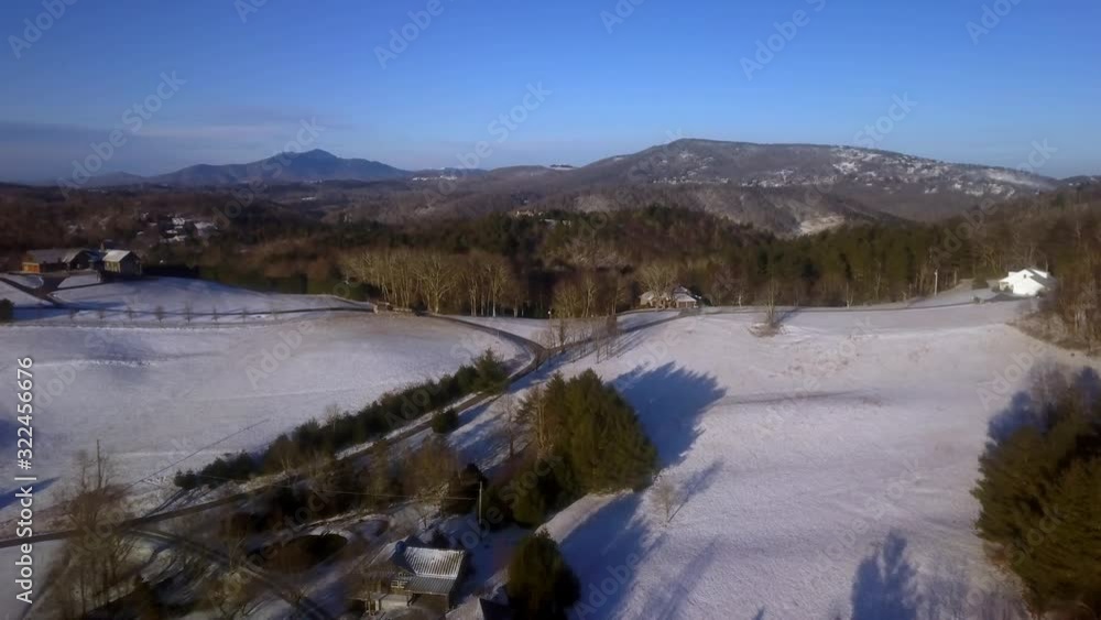 Aerial push, Watauga County North Carolina in snow with Grandfather Mountain in Background Aerial push, Watauga County North Carolina in snow with Grandfather Mountain in Background